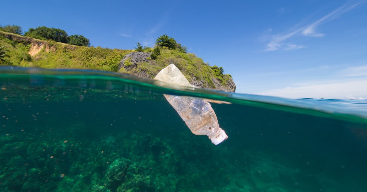 Underwater view of plastic bottle floating in ocean